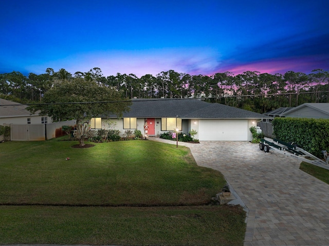 single story home with a yard and a garage