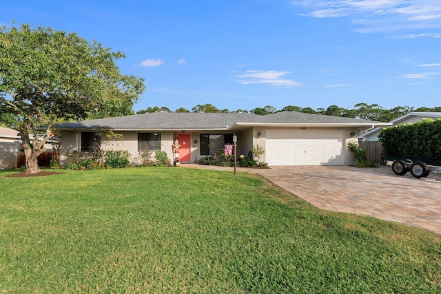 single story home with a garage and a front yard