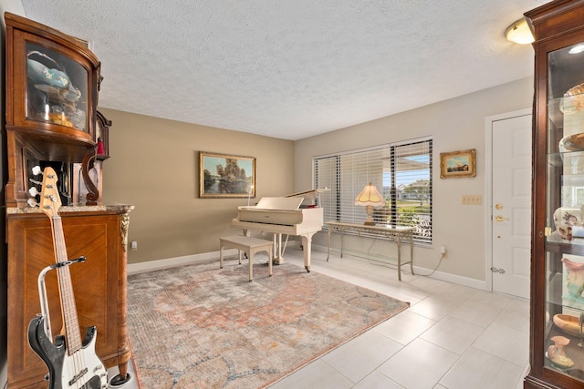 home office featuring light tile patterned flooring and a textured ceiling