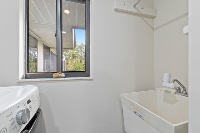 washroom with washer and clothes dryer and sink