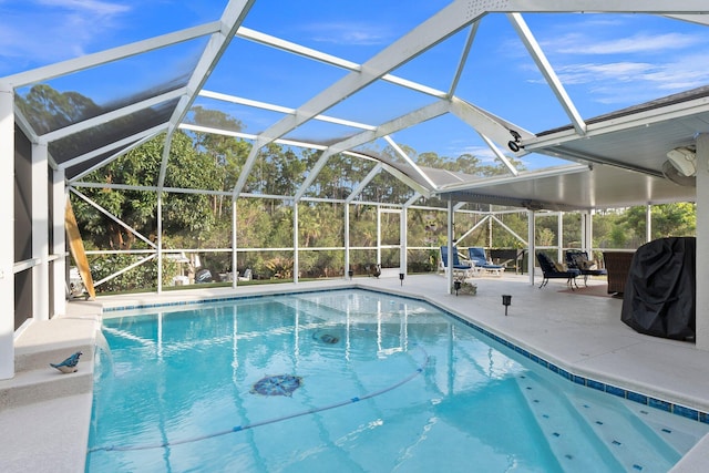 view of pool featuring pool water feature, a lanai, and a patio area