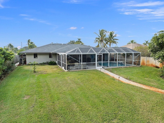 back of property with a patio area, a lanai, and a yard