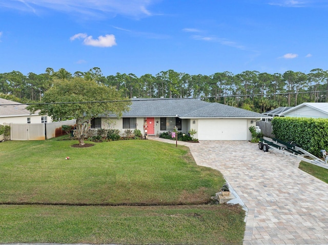 ranch-style home featuring a front yard and a garage