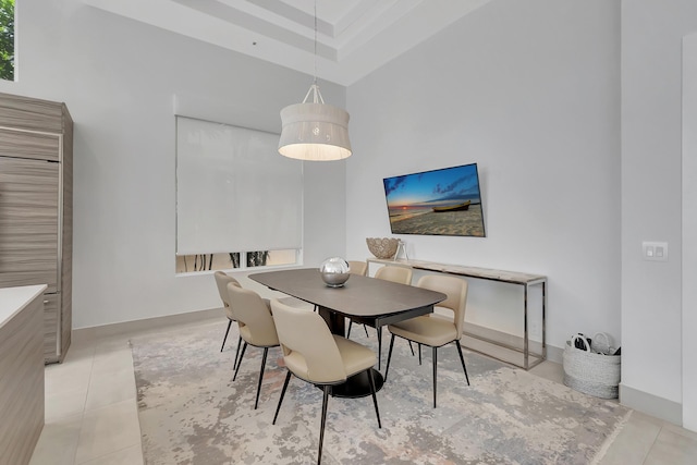 tiled dining area with a high ceiling