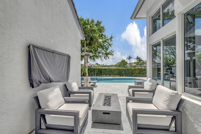 view of patio featuring a fenced in pool and an outdoor fire pit