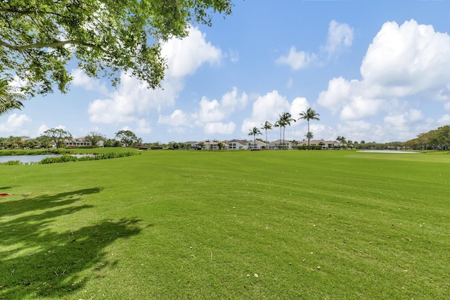 surrounding community featuring a water view and a yard