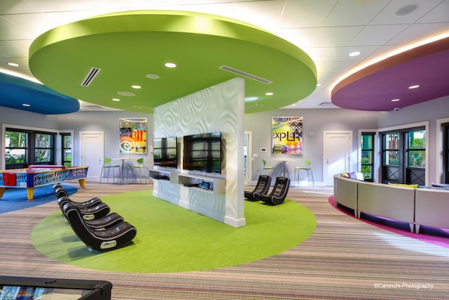 recreation room featuring light colored carpet