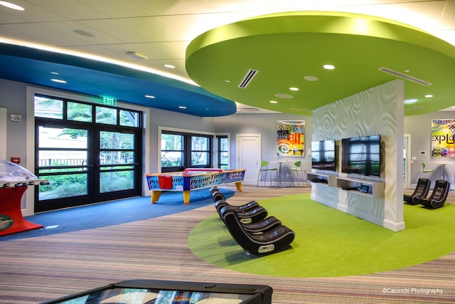 game room with carpet flooring, a healthy amount of sunlight, and french doors