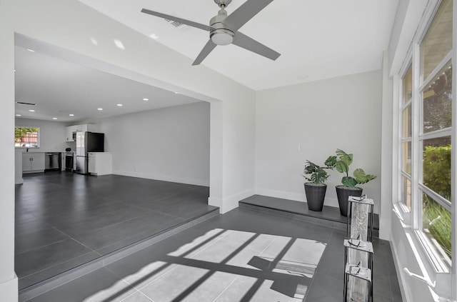 interior space with ceiling fan