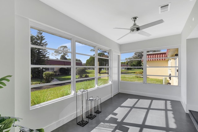 unfurnished sunroom with plenty of natural light and ceiling fan