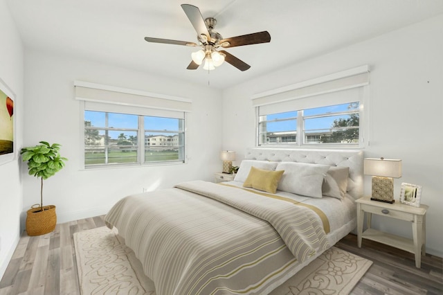 bedroom with ceiling fan and hardwood / wood-style flooring