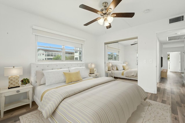 bedroom with ceiling fan, a closet, and dark wood-type flooring