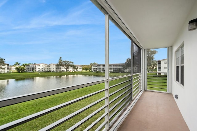 unfurnished sunroom featuring a water view