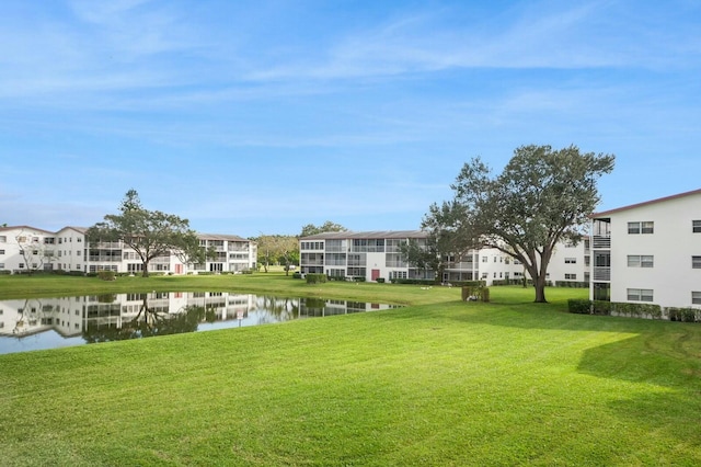 view of community featuring a water view and a lawn