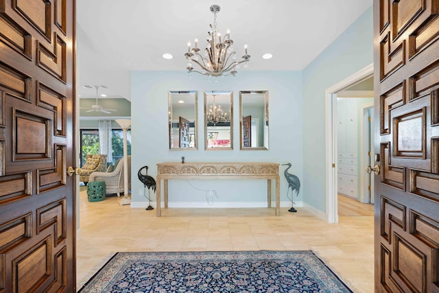 foyer with ceiling fan with notable chandelier