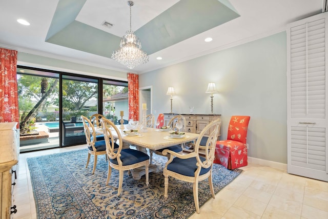 dining room featuring light tile patterned floors, a raised ceiling, crown molding, and a notable chandelier