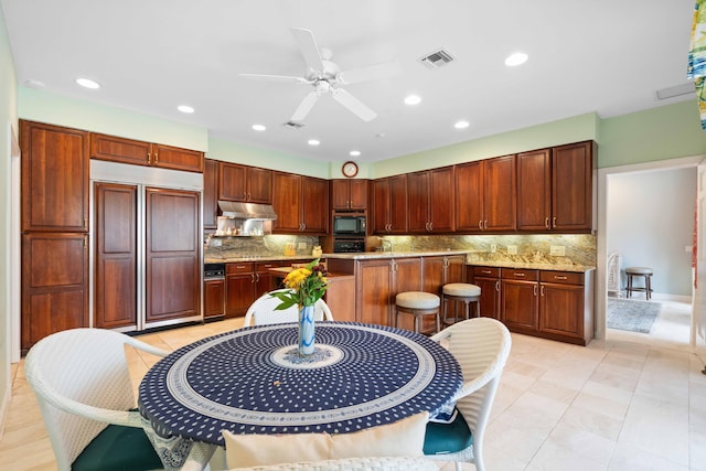 kitchen featuring black appliances, ceiling fan, decorative backsplash, light tile patterned floors, and light stone countertops