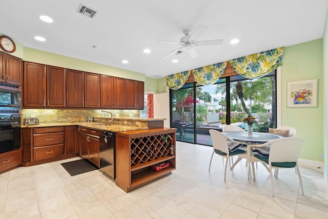 kitchen with black appliances, sink, ceiling fan, light stone countertops, and tasteful backsplash