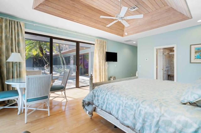 bedroom featuring ensuite bath, access to outside, a tray ceiling, ceiling fan, and wooden ceiling