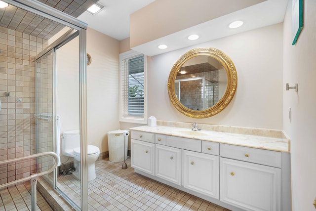 bathroom with tile patterned floors, vanity, toilet, and walk in shower