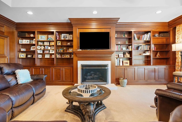 living room with crown molding, built in features, and light colored carpet