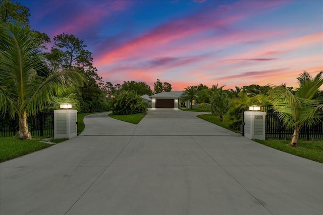 view of front of house with a fenced front yard, a gate, and concrete driveway