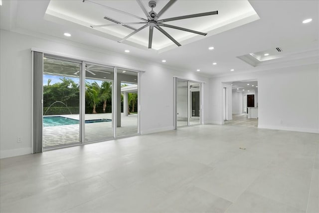 unfurnished room featuring baseboards, a tray ceiling, and ornamental molding