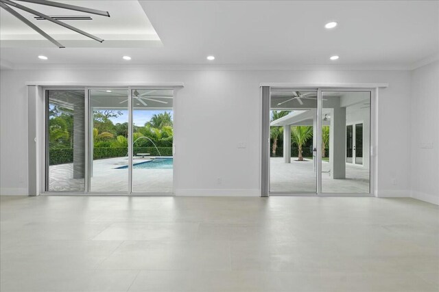 spare room with recessed lighting, a healthy amount of sunlight, and baseboards