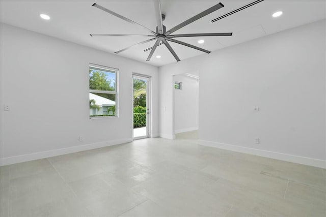 empty room featuring recessed lighting and baseboards