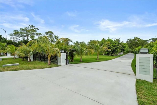 exterior space with a yard, fence, and a gate