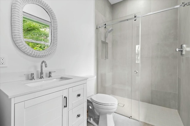 full bathroom with toilet, a shower stall, and vanity