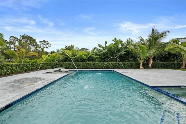 view of swimming pool with a patio and a pool with connected hot tub