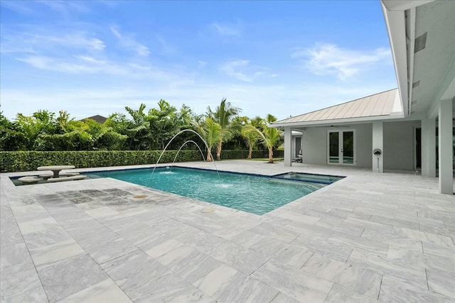 view of pool with french doors, a patio area, and a fenced in pool