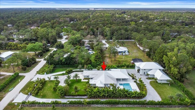 drone / aerial view featuring a view of trees