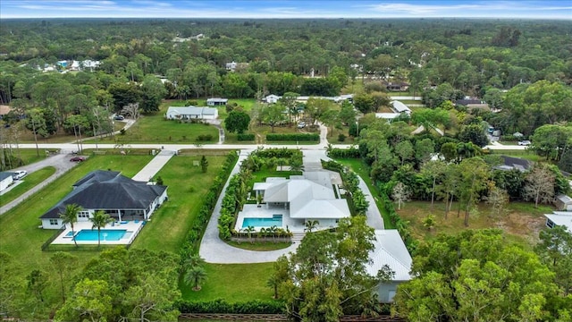 drone / aerial view featuring a forest view