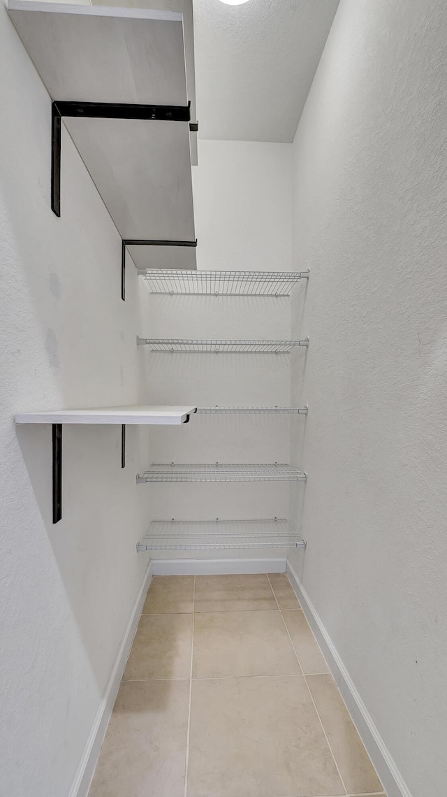 spacious closet featuring tile patterned floors