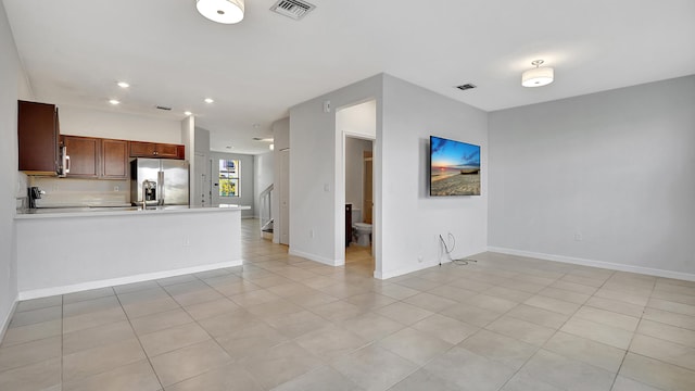 unfurnished living room with light tile patterned floors