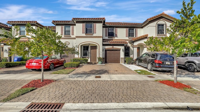 mediterranean / spanish house featuring a garage