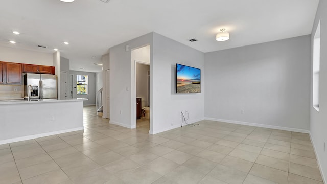 unfurnished living room featuring light tile patterned floors