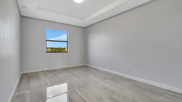 empty room featuring a tray ceiling