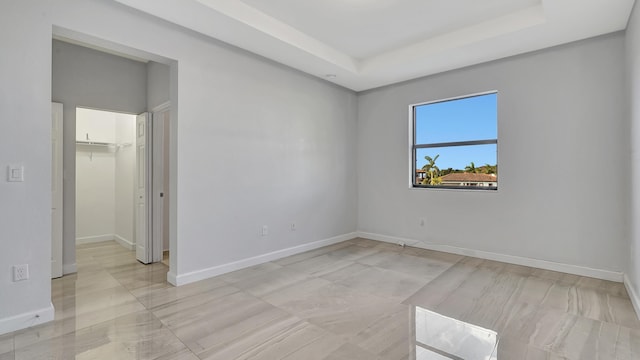 empty room with a raised ceiling