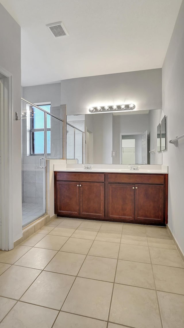 bathroom featuring tile patterned floors, walk in shower, and vanity