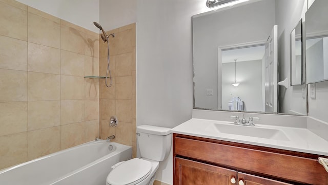 full bathroom with toilet, vanity, and tiled shower / bath