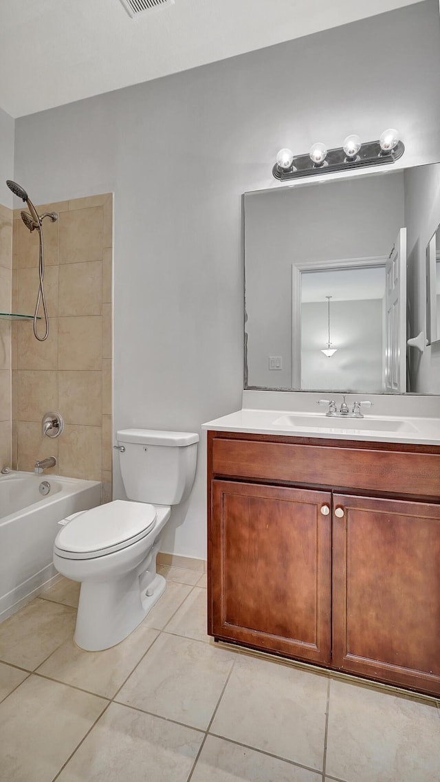 full bathroom featuring toilet, tiled shower / bath combo, tile patterned flooring, and vanity