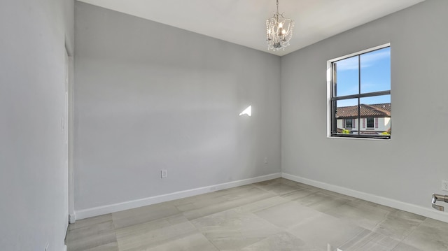 empty room with an inviting chandelier