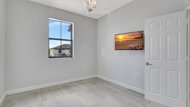 empty room with an inviting chandelier