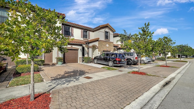 mediterranean / spanish-style home featuring a garage