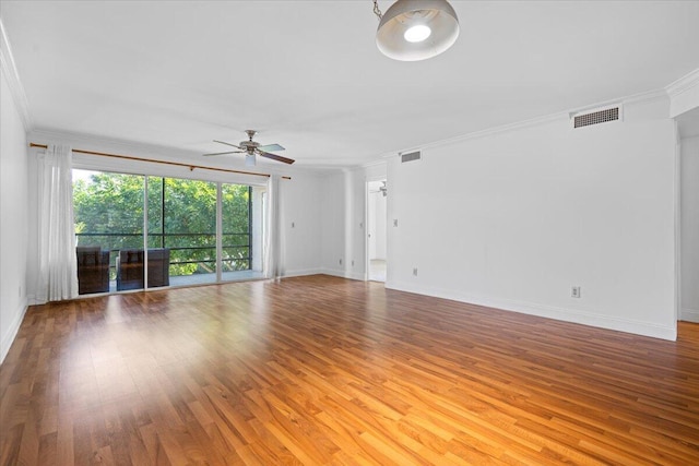 empty room featuring ceiling fan, crown molding, and light wood-type flooring