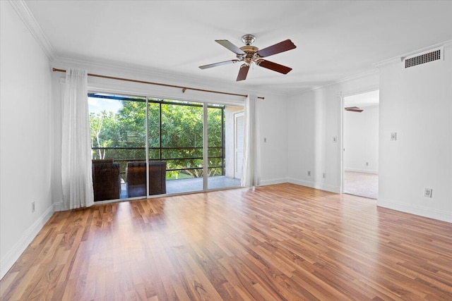 empty room with plenty of natural light, ceiling fan, and crown molding