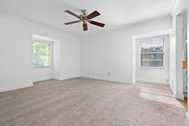 unfurnished room with light carpet, a healthy amount of sunlight, and crown molding